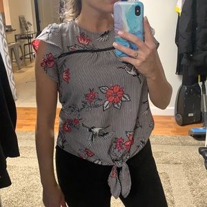 Black and white striped blouse w/pink flowers. Ruffled sleeves & tie at bottom